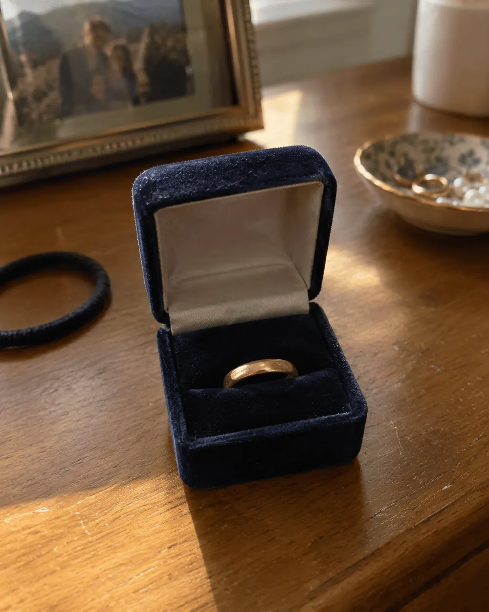 A wedding ring resting alone in a jewelry box